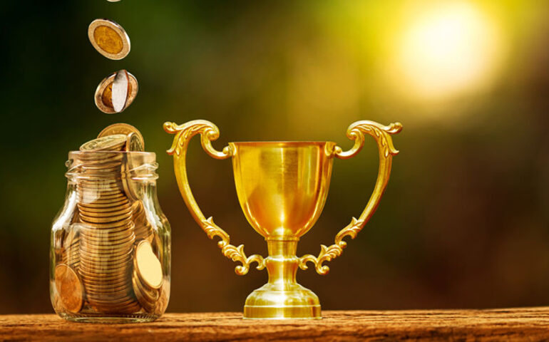 Bottle bank with coin saves and golden a trophy as destinations