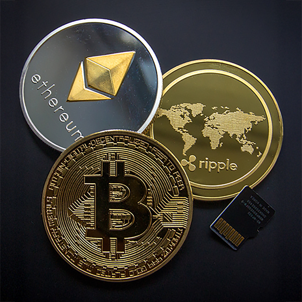 Crypto inheritance Bitcoin, Ethereum, and Ripple coins with microSD card symbolizing crypto inheritance and secure digital asset storage.